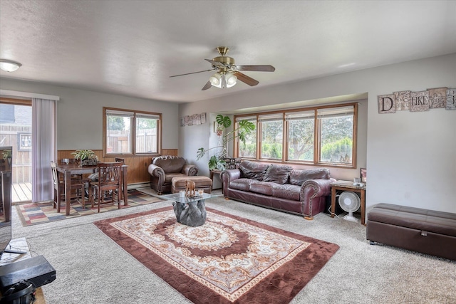 5022 W Garden Springs Ave Unit 5024W, Garden Springs, Spokane, WA 99224 - living room featuring carpet, a ceiling fan, wainscoting, wooden walls, and baseboard heating