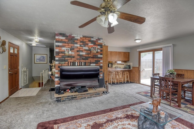5022 W Garden Springs Ave Unit 5024W, Garden Springs, Spokane, WA 99224 - living area with a ceiling fan, carpet floors, a textured ceiling, wainscoting, and wooden walls