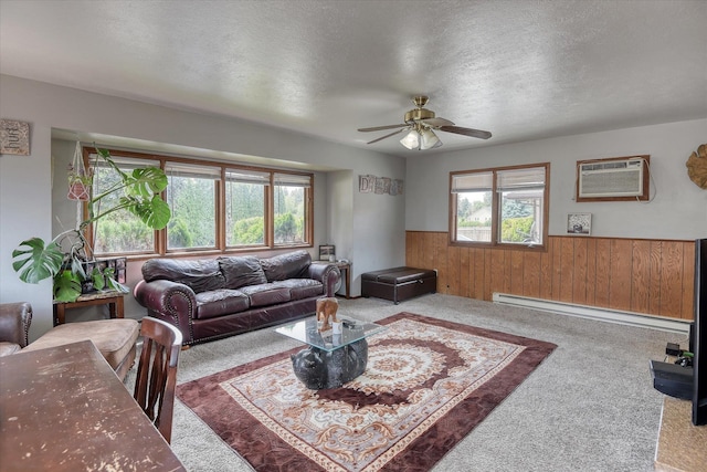 5022 W Garden Springs Ave Unit 5024W, Garden Springs, Spokane, WA 99224 - carpeted living room featuring baseboard heating, an AC wall unit, a wainscoted wall, plenty of natural light, and ceiling fan