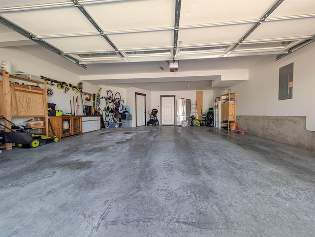 11614 E Rivercrest Dr, Spokane Valley, WA 99206 - garage featuring electric panel, freestanding refrigerator, and a garage door opener