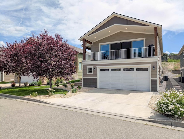 11614 E Rivercrest Dr, Spokane Valley, WA 99206 - view of front of property with concrete driveway, an attached garage, board and batten siding, and a balcony