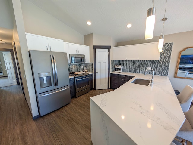 11614 E Rivercrest Dr, Spokane Valley, WA 99206 - kitchen featuring stainless steel appliances, backsplash, a peninsula, decorative light fixtures, and white cabinets