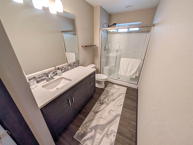 11614 E Rivercrest Dr, Spokane Valley, WA 99206 - full bath featuring wood finished floors, a stall shower, vanity, tasteful backsplash, and a textured wall