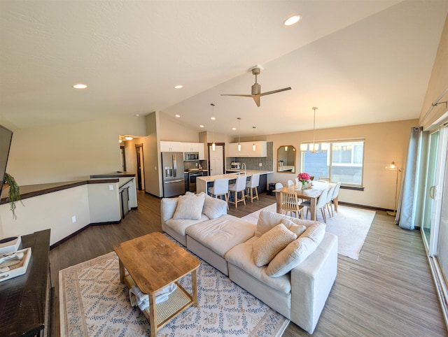 11614 E Rivercrest Dr, Spokane Valley, WA 99206 - living area featuring vaulted ceiling, light wood finished floors, a ceiling fan, recessed lighting, and arched walkways