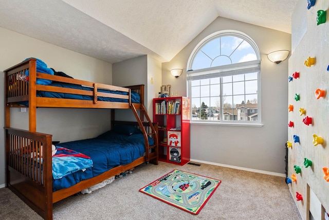 14706 N Mckinnon Ct, Mead, WA 99021 - bedroom featuring multiple windows, vaulted ceiling, carpet flooring, and a textured ceiling