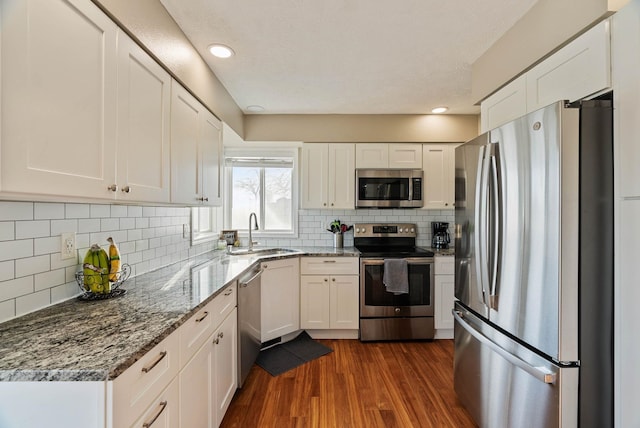 14706 N Mckinnon Ct, Mead, WA 99021 - kitchen with stainless steel appliances, white cabinetry, stone counters, and recessed lighting