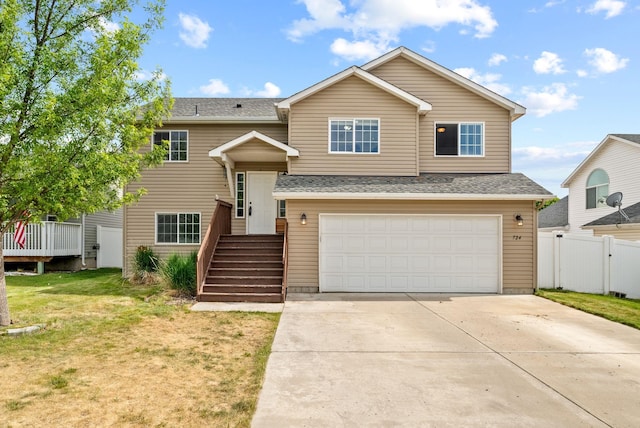 724 E Joshua Dr, Medical Lake, WA 99022 - bi-level home featuring an attached garage, driveway, and roof with shingles