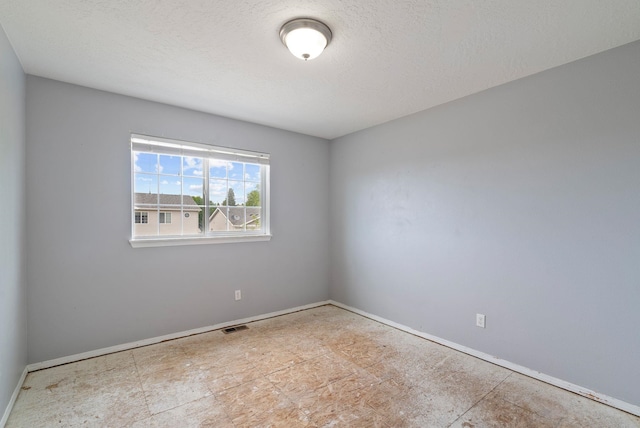 724 E Joshua Dr, Medical Lake, WA 99022 - empty room featuring baseboards and a textured ceiling