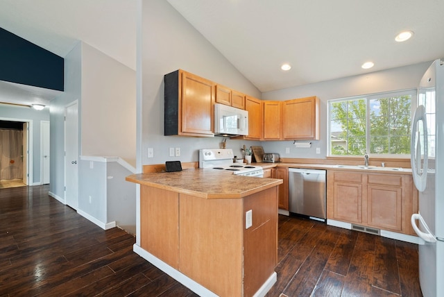 724 E Joshua Dr, Medical Lake, WA 99022 - kitchen featuring white appliances, vaulted ceiling, dark wood-style flooring, a peninsula, and light brown cabinets