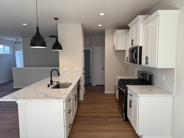 4420 S Willow Ln, Spokane, WA 99216 - kitchen with appliances with stainless steel finishes, recessed lighting, a peninsula, wood finished floors, and tasteful backsplash