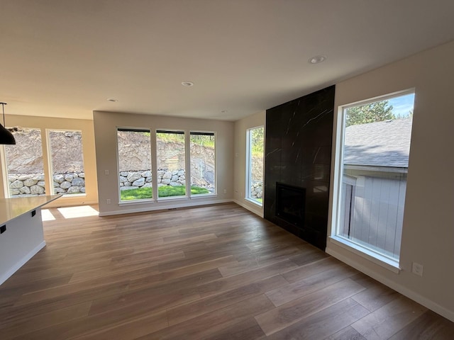 4420 S Willow Ln, Spokane, WA 99216 - unfurnished living room with plenty of natural light, wood finished floors, recessed lighting, and a large fireplace