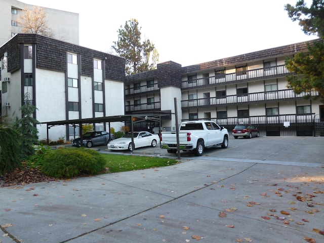 620 W 7th Ave Unit 207, Spokane, WA 99204 - view of property featuring covered and uncovered parking