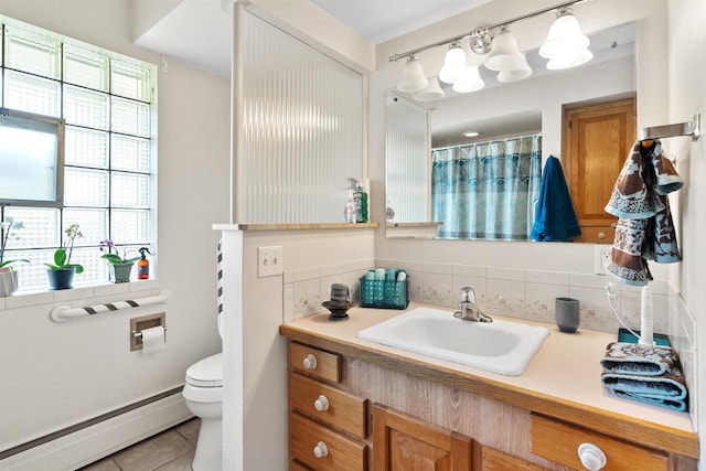 3205 W Hoffman Ave, Spokane, WA 99205 - full bathroom featuring a baseboard heating unit, vanity, tile patterned flooring, and decorative backsplash