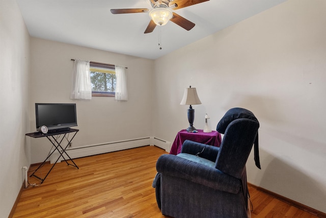 3205 W Hoffman Ave, Spokane, WA 99205 - living area with light wood-style floors, a ceiling fan, and a baseboard radiator