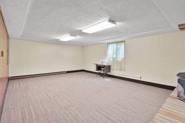 3205 W Hoffman Ave, Spokane, WA 99205 - basement featuring a baseboard radiator, a textured ceiling, and carpet