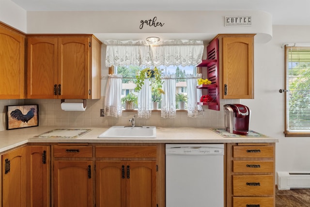 3205 W Hoffman Ave, Spokane, WA 99205 - kitchen featuring white dishwasher, light countertops, decorative backsplash, a baseboard radiator, and brown cabinetry