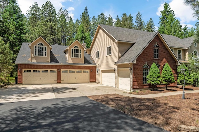 16417 N Napa Ln, Spokane, WA 99208 - view of front of property with concrete driveway, brick siding, a garage, and roof with shingles