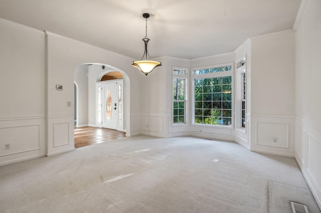16417 N Napa Ln, Spokane, WA 99208 - carpeted spare room with a decorative wall, arched walkways, wainscoting, and crown molding