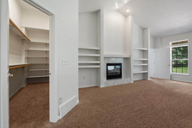 16417 N Napa Ln, Spokane, WA 99208 - unfurnished living room featuring carpet, vaulted ceiling, a high end fireplace, and built in features