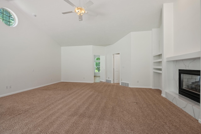 16417 N Napa Ln, Spokane, WA 99208 - unfurnished living room with carpet floors, ceiling fan, a glass covered fireplace, and vaulted ceiling