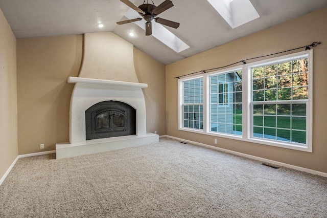 16417 N Napa Ln, Spokane, WA 99208 - unfurnished living room featuring a skylight, ceiling fan, lofted ceiling, carpet flooring, and a tile fireplace
