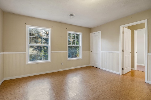 16417 N Napa Ln, Spokane, WA 99208 - unfurnished bedroom with a wainscoted wall and wood finished floors