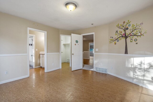 16417 N Napa Ln, Spokane, WA 99208 - unfurnished room featuring wood finished floors and a wainscoted wall