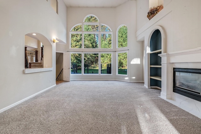 16417 N Napa Ln, Spokane, WA 99208 - unfurnished living room with a towering ceiling, carpet, and a fireplace