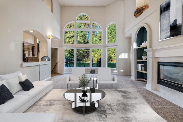 16417 N Napa Ln, Spokane, WA 99208 - living room featuring a high ceiling, a tiled fireplace, and carpet flooring