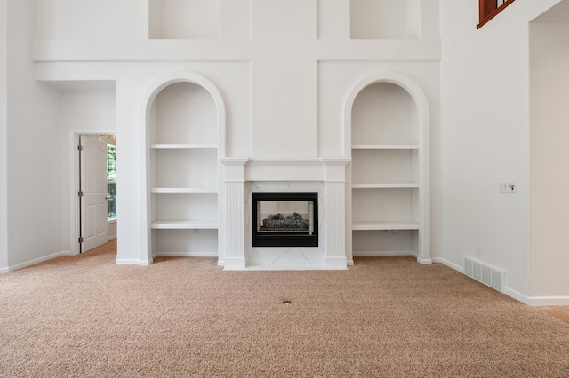 16417 N Napa Ln, Spokane, WA 99208 - unfurnished living room with carpet floors, a multi sided fireplace, and built in features
