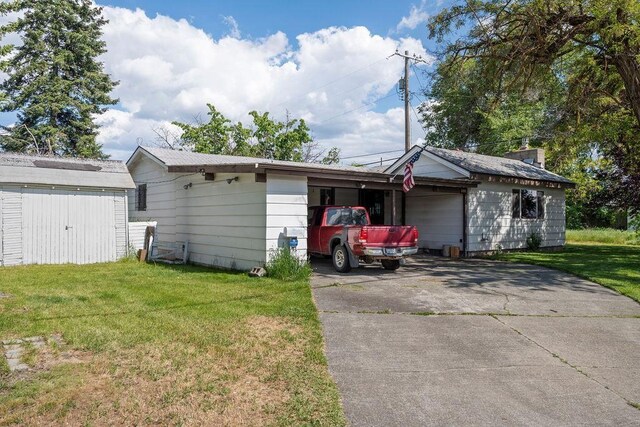 2920 N Regal St, Spokane, WA 99207 - view of home's exterior with a lawn, driveway, and a storage shed