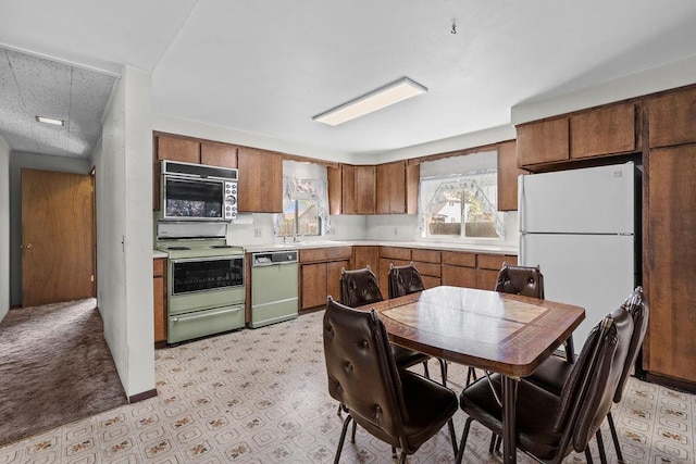2920 N Regal St, Spokane, WA 99207 - kitchen featuring white appliances, light countertops, and brown cabinets