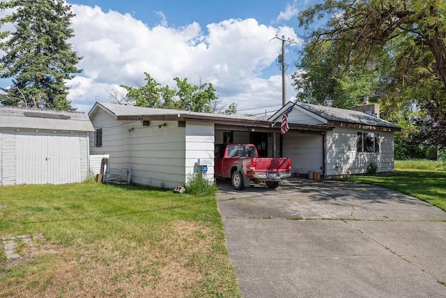 2920 N Regal St, Spokane, WA 99207 - view of home's exterior with a lawn, driveway, and a storage shed