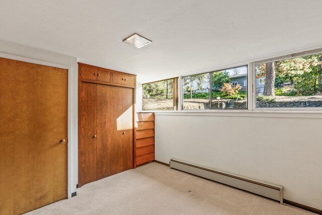 3717 E 17th Ave, Spokane, WA 99223 - unfurnished bedroom featuring a baseboard radiator and light carpet