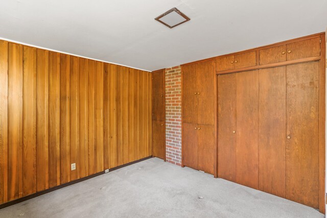 3717 E 17th Ave, Spokane, WA 99223 - unfurnished bedroom with light colored carpet, a closet, and wood walls