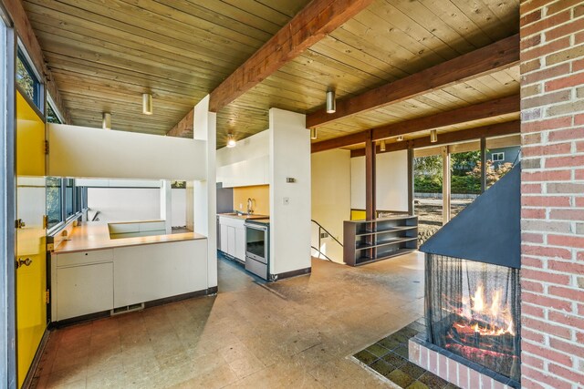 3717 E 17th Ave, Spokane, WA 99223 - kitchen featuring a wood ceiling with exposed beams and stainless steel electric range oven