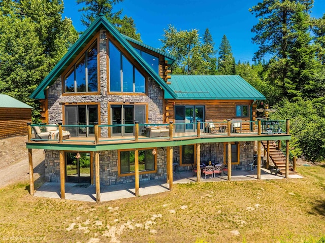 32261 N Leclerc Rd, Ione, WA 99139 - rear view of house featuring stone siding, a patio area, and a lawn