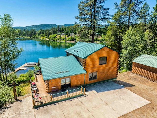 32261 N Leclerc Rd, Ione, WA 99139 - back of property with log siding, a water and mountain view, a forest view, a metal roof, and a patio area
