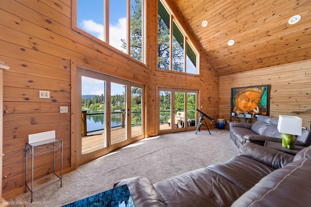 32261 N Leclerc Rd, Ione, WA 99139 - living room featuring high vaulted ceiling, wood walls, carpet, french doors, and a water view