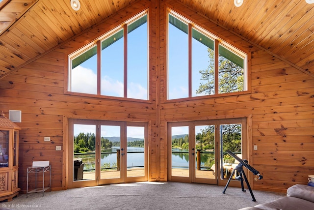 32261 N Leclerc Rd, Ione, WA 99139 - living room with a water view, high vaulted ceiling, wooden walls, wooden ceiling, and carpet floors