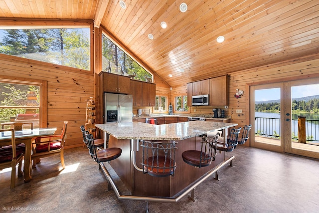 32261 N Leclerc Rd, Ione, WA 99139 - kitchen with stainless steel appliances, wood walls, high vaulted ceiling, wood ceiling, and a large island