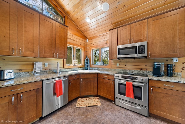 32261 N Leclerc Rd, Ione, WA 99139 - kitchen with appliances with stainless steel finishes, lofted ceiling, wood ceiling, brown cabinetry, and light stone counters