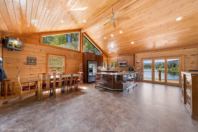 32261 N Leclerc Rd, Ione, WA 99139 - living area featuring lofted ceiling, wooden walls, wooden ceiling, and ceiling fan
