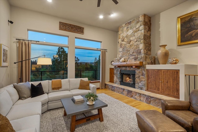 2415 E Hangman Creek Ln, Spokane, WA 99224 - living room featuring ceiling fan, wood finished floors, and a stone fireplace