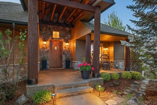 2415 E Hangman Creek Ln, Spokane, WA 99224 - doorway to property with stone siding, covered porch, and a shingled roof