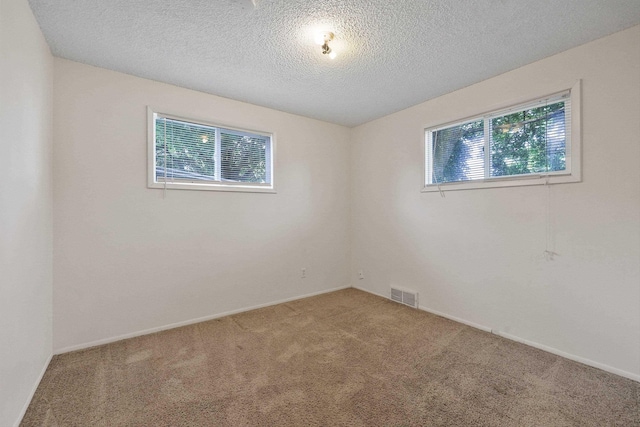 621 E Dalke Ave, Spokane, WA 99208 - spare room with carpet flooring and a textured ceiling