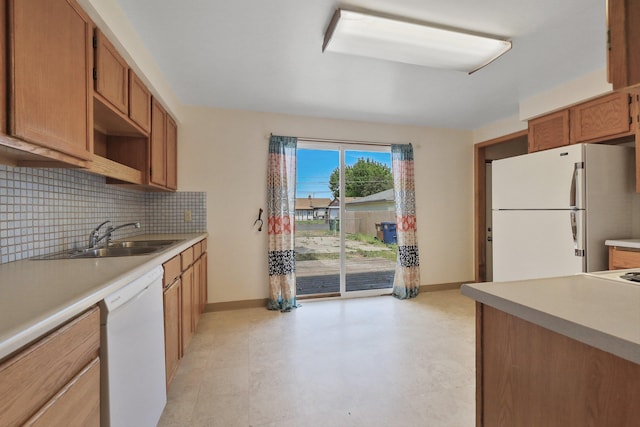 621 E Dalke Ave, Spokane, WA 99208 - kitchen featuring white appliances, light countertops, tasteful backsplash, and brown cabinetry
