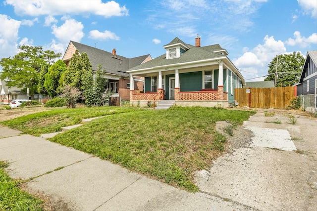 524 W Montgomery Ave, Spokane, WA 99205 - view of front of home with covered porch, a chimney, brick siding, and a shingled roof
