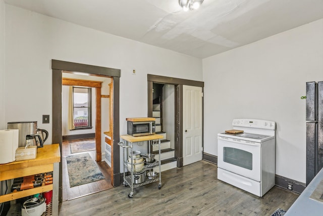 524 W Montgomery Ave, Spokane, WA 99205 - kitchen featuring white electric range oven, stainless steel microwave, wood finished floors, and freestanding refrigerator