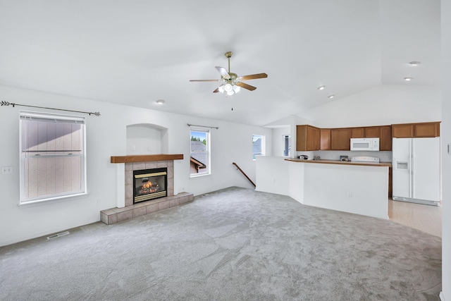 5019 W W Prosperity Ln, Spokane, WA 99208 - unfurnished living room featuring ceiling fan, light carpet, lofted ceiling, and a tiled fireplace